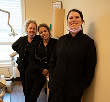 Panama City dentist smiling with senior man in dental chair